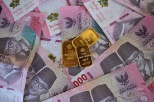 Photo by Robert Lens Close-up of Indonesian Rupiah banknotes with fine gold bars, symbolizing wealth and investment.