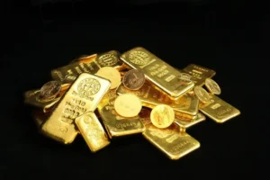Photo by Zlaťáky.cz Close-up of shiny gold bars and coins symbolizing wealth and prosperity.