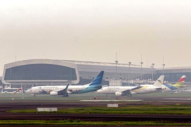 Pesawat komersial sedang bersiap lepas landas di landasan pacu bandara